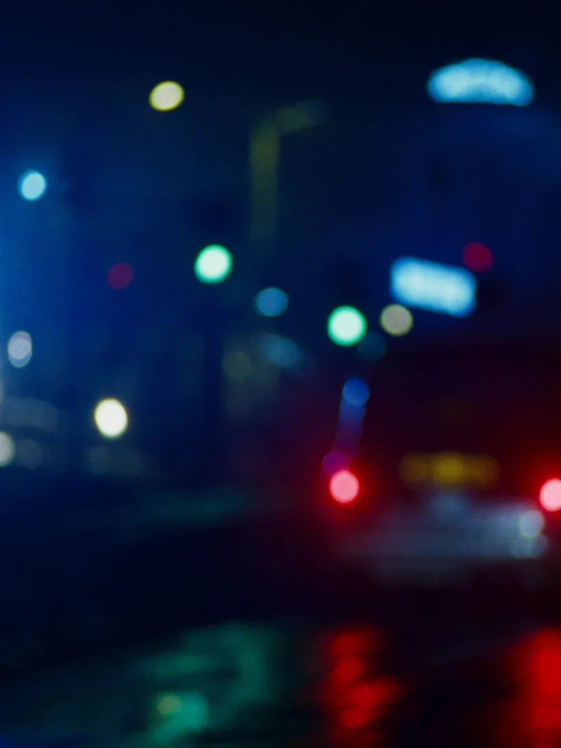 Town-centre nightlife with neon lights and a waiting taxi